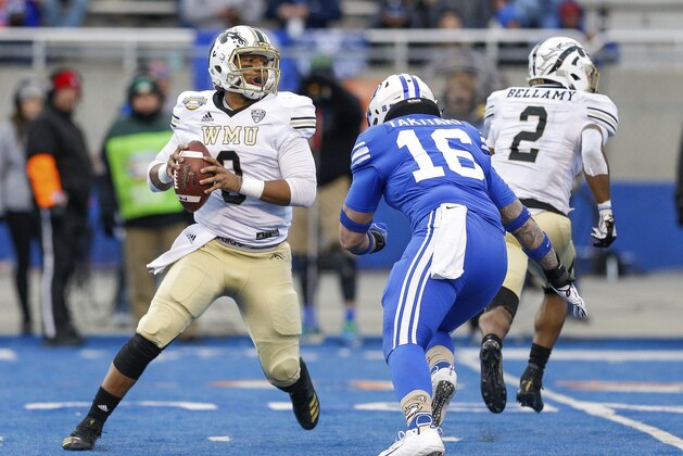 Western Michigan quarterback Kaleb Eleby, left, reacts to pressure BYU linebacker Sione Takitaki (16) in the second half of the Famous Idaho Potato Bowl an NCAA college football game, Friday, Dec. 21, 2018, in Boise, Idaho. BYU won 49-18. (AP Photo/Steve Conner)
