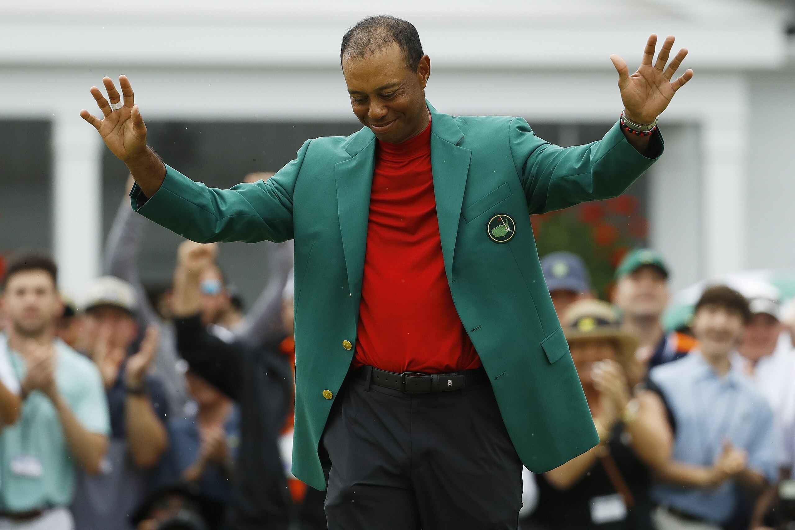 FILE - In this April 14, 2019,  file photo, Tiger Woods smiles as he wears his green jacket after winning the Masters golf tournament in Augusta, Ga. Fourteen years after his last Masters win and 11 years after his last major, after fighting through chronic back problems, multiple surgeries, a bout with painkillers and long after just about everybody had written him off, Woods claimed his fifth green jacket. (AP Photo/Matt Slocum, File)