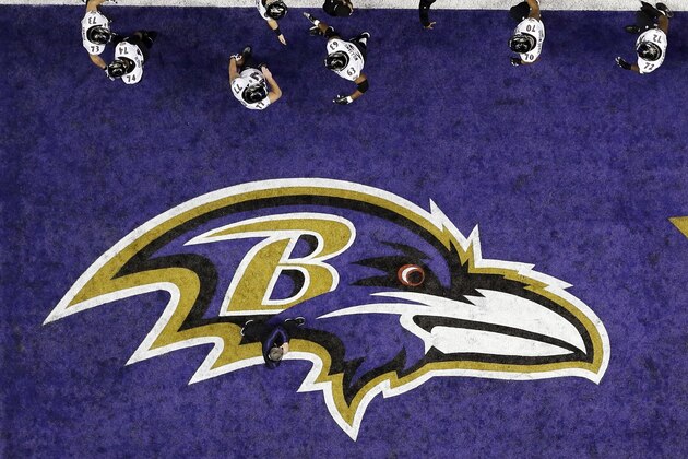 The Baltimore Ravens walk past the team logo in the end zone during warmups for the NFL Super Bowl XLVII football game against the San Francisco 49ers, Sunday, Feb. 3, 2013, in New Orleans. (AP Photo/David J. Phillip)