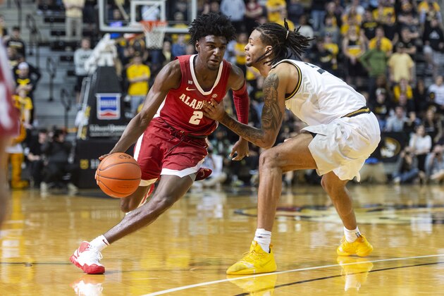 Alabama's Kira Lewis Jr., left, dribbles past Missouri's Mitchell Smith, right, during the first half of an NCAA college basketball game Saturday, March 7, 2020, in Columbia, Mo. (AP Photo/L.G. Patterson)