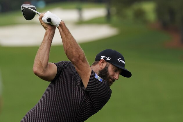 Dustin Johnson hits on the first fairway during a practice round for the Masters golf tournament Wednesday, Nov. 11, 2020, in Augusta, Ga. (AP Photo/David J. Phillip)