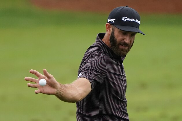 Dustin Johnson catches a ball at the practice area during the Masters golf tournament Wednesday, Nov. 11, 2020, in Augusta, Ga. (AP Photo/Matt Slocum)