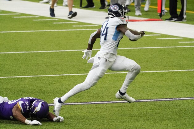 Tennessee Titans wide receiver Corey Davis, right, runs from Minnesota Vikings linebacker Eric Wilson after catching a pass during the second half of an NFL football game, Sunday, Sept. 27, 2020, in Minneapolis. (AP Photo/Jim Mone)