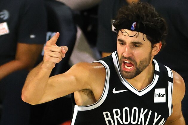 Joe Harris of the Brooklyn Nets reacts after hitting a three point basket against the Toronto Raptors during the fourth quarter of Game 2 of an NBA basketball first-round playoff series, Wednesday, Aug. 19, 2020, in Lake Buena Vista, Fla. (Kevin C. Cox/Pool Photo via AP)