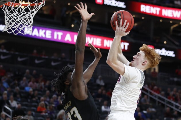 Arizona's Nico Mannion (1) shoots over Washington's Isaiah Stewart (33) during the second half of an NCAA college basketball game in the first round of the Pac-12 men's tournament Wednesday, March 11, 2020, in Las Vegas. (AP Photo/John Locher)