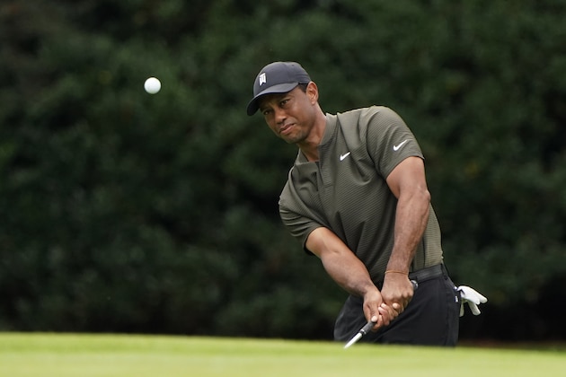 Tiger Woods chips to the 15th green during the first round of the Masters golf tournament Thursday, Nov. 12, 2020, in Augusta, Ga. (AP Photo/Chris Carlson)