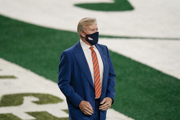 John Elway, president of football operations for the Denver Broncos, watches his team warm up before an NFL football game against the New York Jets Thursday, Oct. 1, 2020, in East Rutherford, N.J. (AP Photo/Seth Wenig)