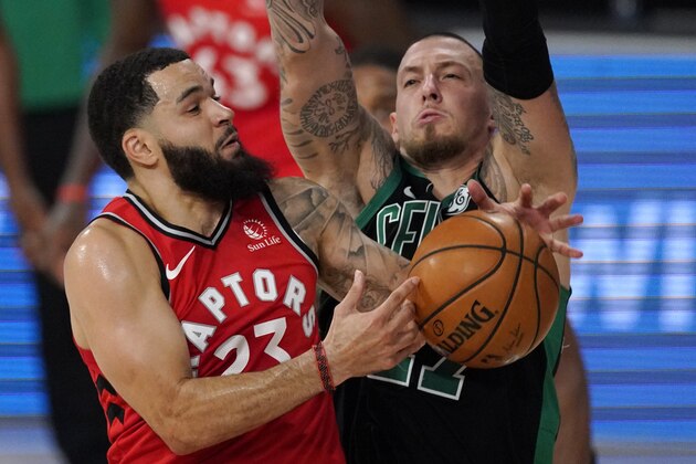 Toronto Raptors' Fred VanVleet (23) fights for the ball with Boston Celtics' Daniel Theis (27) during the first half of an NBA conference semifinal playoff basketball game Monday, Sept. 7, 2020, in Lake Buena Vista, Fla. (AP Photo/Mark J. Terrill)