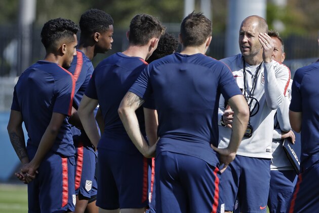 FILE - In this Wednesday, Jan. 8, 2020, file photo, Gregg Berhalter, right, head coach of the U.S. Men's National Soccer team, instructs some of his players during drills in Bradenton, Fla. The fallout of the coronavirus pandemic could benefit the U.S. soccer team when World Cup qualifying begins in North and Central America and the Caribbean. “If we go to qualifying in empty stadiums, that’s going to change that dynamic considerably, some for the positive and some for the worse,” Berhalter said Tuesday, July 21, 2020. (AP Photo/Chris O'Meara, File)