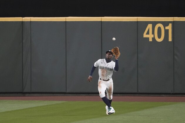 Seattle Mariners right fielder Kyle Lewis catches a fly ball hit by Houston Astros' Yuli Gurriel during the ninth inning of a baseball game Wednesday, Sept. 23, 2020, in Seattle. The Mariners won 3-2. (AP Photo/Ted S. Warren)
