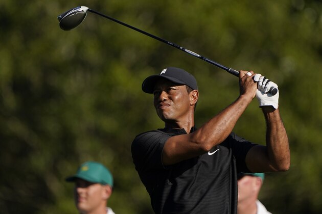 Tiger Woods watches his tee shot on the first hole during the second round of the Masters golf tournament Friday, Nov. 13, 2020, in Augusta, Ga. (AP Photo/Chris Carlson)