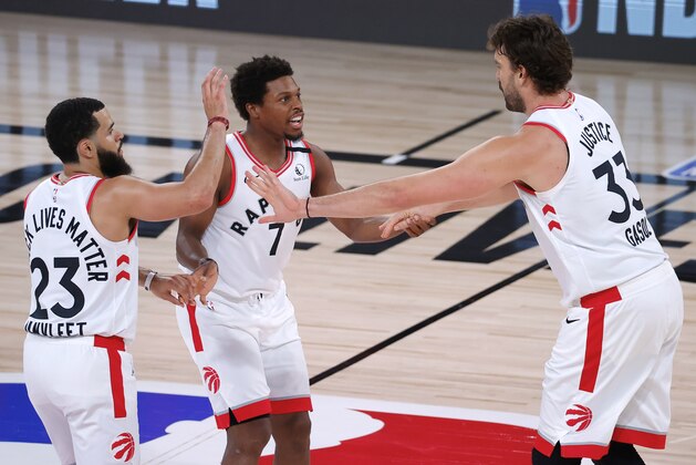 Toronto Raptors' Marc Gasol, right, celebrates a basket against the Brooklyn Nets with Fred VanVleet, left, and Kyle Lowry during Game 1 of an NBA basketball first-round playoff series, Monday, Aug. 17, 2020, in Lake Buena Vista, Fla. (Kevin C. Cox/Pool Photo via AP)