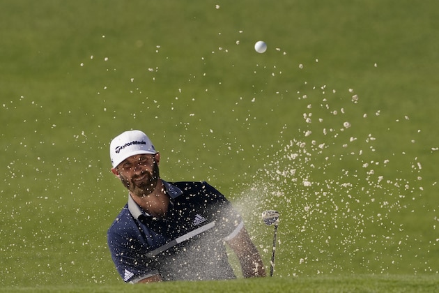 Dustin Johnson watches his bunker shot on the second hole during the second round of the Masters golf tournament Friday, Nov. 13, 2020, in Augusta, Ga. (AP Photo/Charlie Riedel)