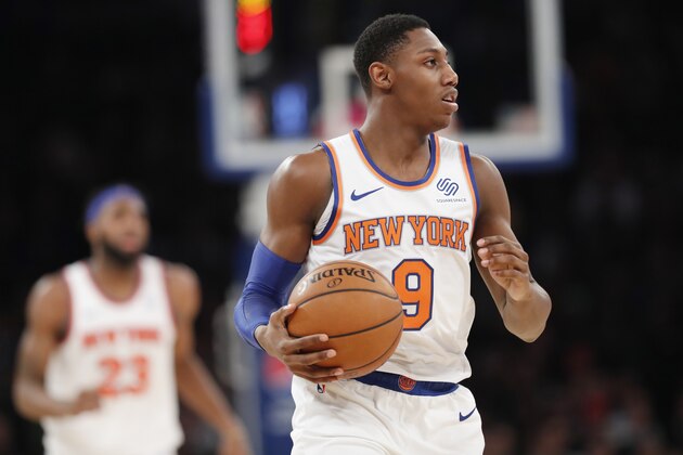 New York Knicks forward RJ Barrett (9) holds theh ball as he walks slowly down court during the second half of an NBA basketball game against the Atlanta Hawks in New York, Tuesday, Dec. 17, 2019. The Knicks defeated the Hawks 143-120. New York Knicks center Mitchell Robinson (23) is at left rear. (AP Photo/Kathy Willens)