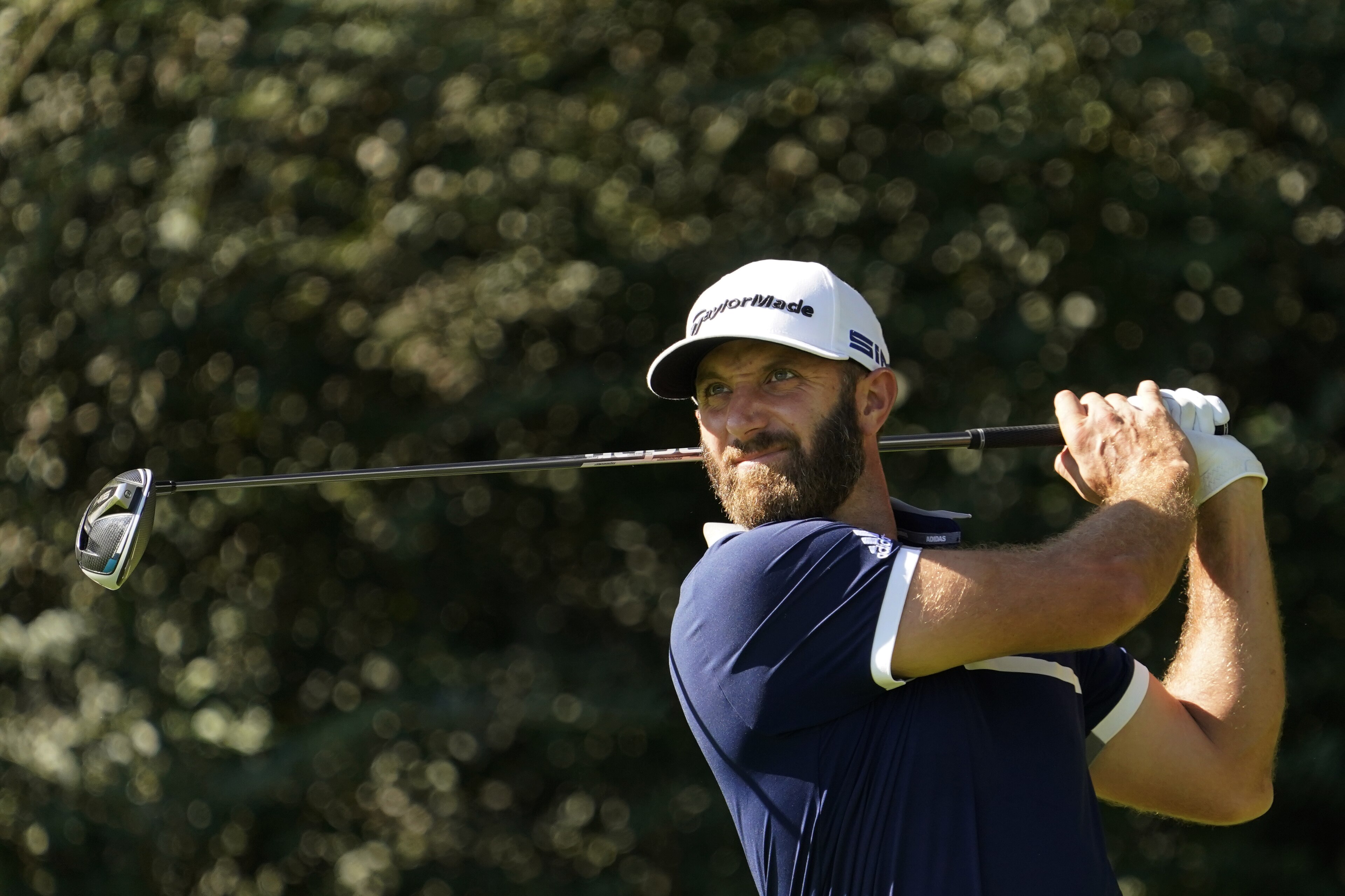 Dustin Johnson watches his tee shot on the 14th hole during the second round of the Masters golf tournament Friday, Nov. 13, 2020, in Augusta, Ga. (AP Photo/David J. Phillip)