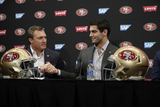 San Francisco 49ers quarterback Jimmy Garoppolo, right, shakes hands with general manager John Lynch during an NFL football press conference Friday, Feb. 9, 2018, in Santa Clara, Calif. Garoppolo has signed a five-year contract with the 49ers worth a record-breaking $137.5 million. (AP Photo/Marcio Jose Sanchez)