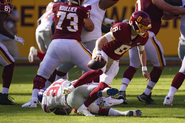 Washington Football Team quarterback Kyle Allen (8) foot is caught underneath a falling New York Giants strong safety Jabrill Peppers (21) in the first half of an NFL football game between the New York Giants and Washington Football Team, Sunday, Nov. 8, 2020, in Landover, Md. (AP Photo/Patrick Semansky)
