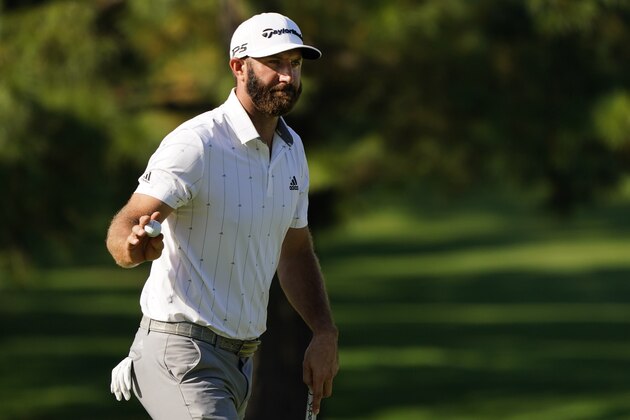 Dustin Johnson waves his ball after a birdie on the seventh hole during the third round of the Masters golf tournament Saturday, Nov. 14, 2020, in Augusta, Ga. (AP Photo/Matt Slocum)
