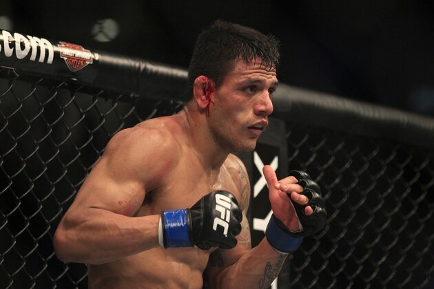 Rafael Dos Anjos fights Gleison Tibau during a UFC 139 Mixed Martial Arts lightweight bout in San Jose, Calif., Saturday, Nov. 19, 2011. (AP Photo/Jeff Chiu)