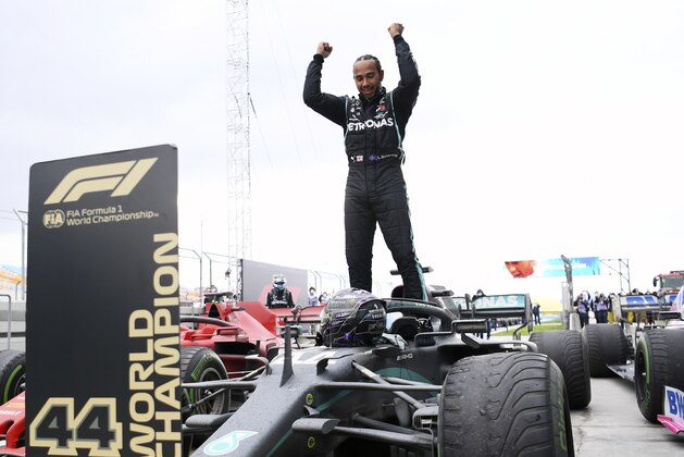 Mercedes driver Lewis Hamilton of Britain celebrates after winning the Turkish Formula One Grand Prix at the Istanbul Park circuit racetrack in Istanbul, Sunday, Nov. 15, 2020. (Clive Mason/Pool via AP)