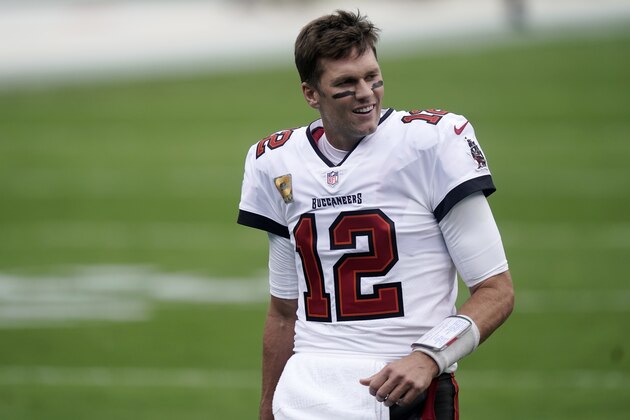 Tampa Bay Buccaneers quarterback Tom Brady (12) walks the turf before the first half of an NFL football game between the Carolina Panthers and the Tampa Bay Buccaneers, Sunday, Nov. 15, 2020, in Charlotte , N.C. (AP Photo/Gerry Broome)