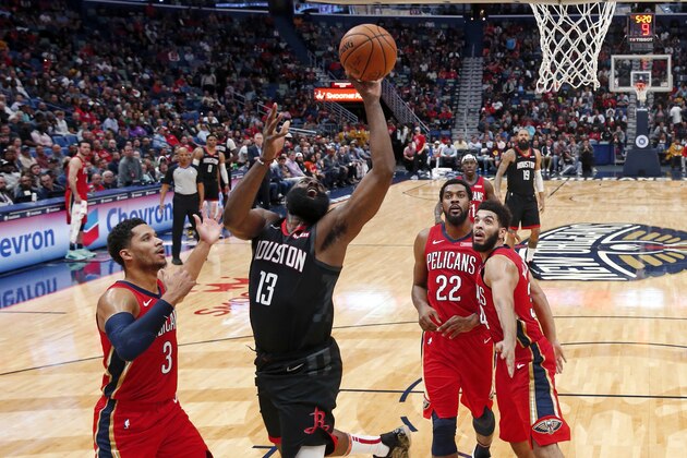 Houston Rockets guard James Harden (13) drives to the basket between New Orleans Pelicans guard Josh Hart (3), center Derrick Favors (22) and guard Kenrich Williams (34) in the second half of an NBA basketball game in New Orleans, Monday, Nov. 11, 2019. The Rockets won 122-116. (AP Photo/Gerald Herbert)