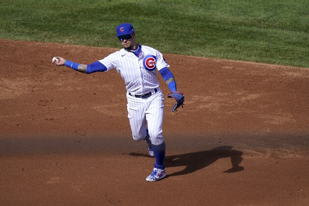 Chicago Cubs shortstop Javier Baez throws out Miami Marlins' Chad Wallach at first during the third inning in Game 2 of a National League wild-card baseball series Friday, Oct. 2, 2020, in Chicago. (AP Photo/Nam Y. Huh)