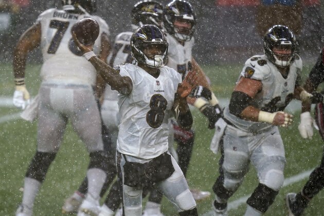 Baltimore Ravens quarterback Lamar Jackson passes during torrential rain in the second half of an NFL football game against the New England Patriots, Sunday, Nov. 15, 2020, in Foxborough, Mass. (AP Photo/Elise Amendola)