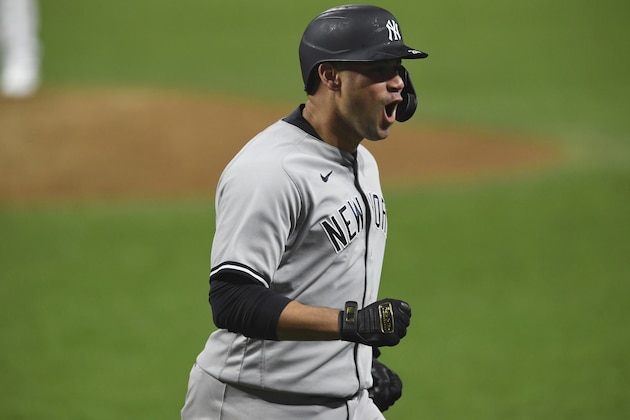 New York Yankees' Gary Sanchez reacts after hitting a two-run home run off Cleveland Indians relief pitcher Triston McKenzie durng the sixth inning of Game 2 of an American League wild-card baseball series, Wednesday, Sept. 30, 2020, in Cleveland. (AP Photo/David Dermer)