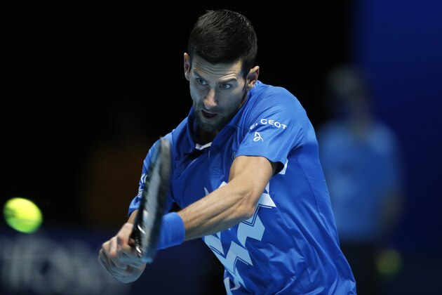 Novak Djokovic of Serbia plays a return to Diego Schwartzman of Argentina during their singles tennis match at the ATP World Finals tennis tournament at the O2 arena in London, Monday, Nov. 16, 2020. (AP Photo/Frank Augstein)