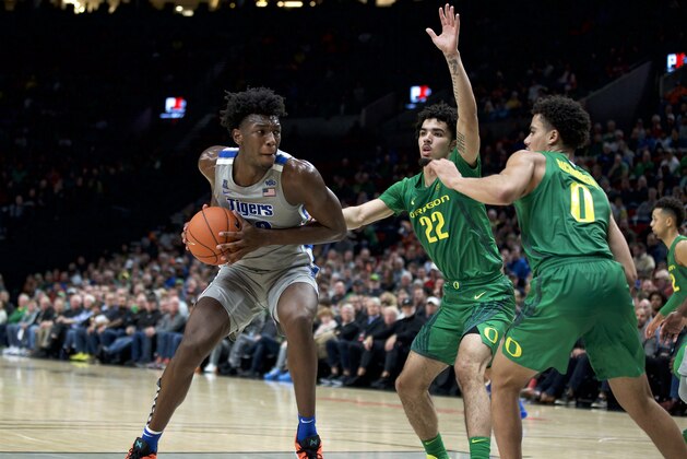 Memphis center James Wiseman, left, drives to the basket as Oregon guard Addison Patterson, center, and guard Will Richardson defend during the second half of an NCAA college basketball game in Portland, Ore., Tuesday, Nov. 12, 2019. Oregon won 82-74. (AP Photo/Craig Mitchelldyer)