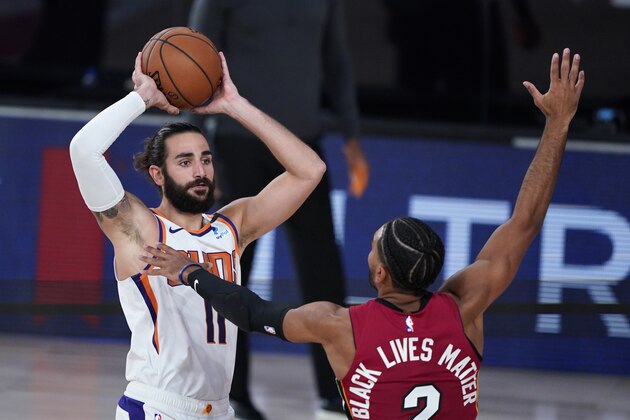 Phoenix Suns' Ricky Rubio (11) looks to pass as Miami Heat guard Gabe Vincent (2) defends during the second half of an NBA basketball game, Saturday, Aug. 8, 2020, in Lake Buena Vista, Fla. (AP Photo/Ashley Landis, Pool)