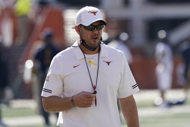 Texas head coach Tom Herman watches his team warm up before an NCAA college football game against West Virginia in Austin, Texas, Saturday, Nov. 7, 2020. (AP Photo/Chuck Burton)