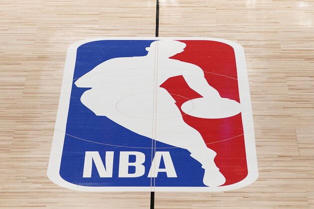 Black Lives Matter is displayed near the NBA logo in an empty basketball arena Friday, Aug. 28, 2020, in Lake Buena Vista, Fla.  The NBA playoffs will resume Saturday after the league and the National Basketball Players Association detailed the commitments that made players comfortable continuing the postseason. (AP Photo/Ashley Landis, Pool)