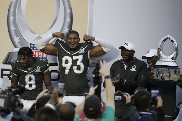 AFC defensive end Calais Campbell, of the Jacksonville Jaguars, (93) and quarterback Lamar Jackson, of the Baltimore Ravens, celebrate at the end of the NFL Pro Bowl football game against the NFC, Sunday, Jan. 26, 2020, in Orlando, Fla. The AFC defeated the NFC 38-33.(AP Photo/John Raoux)