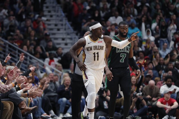 New Orleans Pelicans guard Jrue Holiday (11) reacts in front of Boston Celtics guard Jaylen Brown (7) after making a 3-point basket in the second half of an NBA basketball game in New Orleans, Sunday, Jan. 26, 2020. The Pelicans won 123-108. (AP Photo/Gerald Herbert)