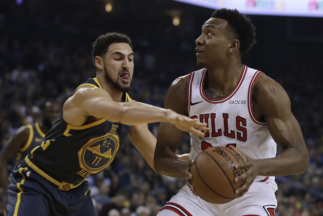 Chicago Bulls' Wendell Carter Jr., right, looks to shoot against Golden State Warriors' Klay Thompson (11) during the first half of an NBA basketball game Friday, Jan. 11, 2019, in Oakland, Calif. (AP Photo/Ben Margot)