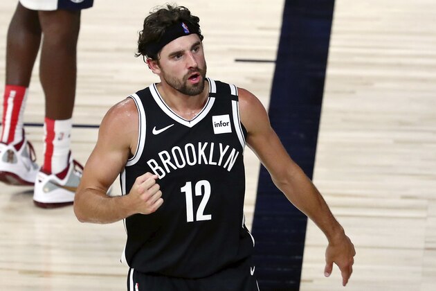 Brooklyn Nets forward Joe Harris (12) reacts after a play against the Washington Wizards in the second half of an NBA basketball game Sunday, Aug. 2, 2020, in Lake Buena Vista, Fla. (Kim Klement/Pool Photo via AP)