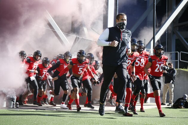 Cincinnati head coach Luke Fickell, front right, leads the team onto the field against Memphis before the start of an NCAA college football game Saturday, Oct. 31, 2020, in Cincinnati. (Photo by Gary Landers)