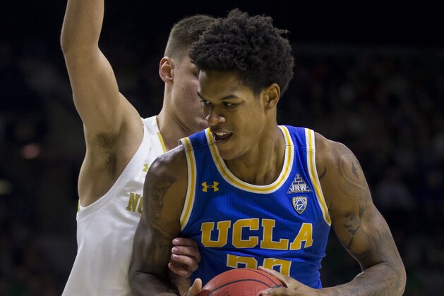 UCLA's Shareef O'Neal, right, gets pressure from Notre Dame's Nate Laszewski during an NCAA college basketball game Saturday, Dec. 14, 2019, in South Bend, Ind. Notre Dame won 75-61. (AP Photo/Robert Franklin)
