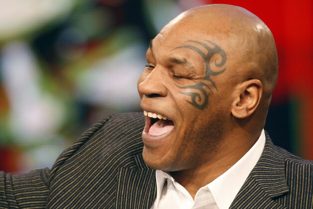 Former heavyweight boxing champion Mike Tyson reacts during the taping of the