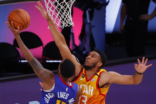 Utah Jazz's Tony Bradley, right, defends against Denver Nuggets' Monte Morris during the third quarterof Game 4 of an NBA basketball first-round playoff series, Sunday, Aug. 23, 2020, in Lake Buena Vista, Fla. (Kevin C. Cox/Pool Photo via AP)