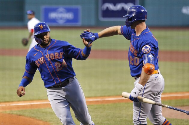 New York Mets' Robinson Cano (24) celebrates with Pete Alonso (20) after scoring with Yoenis Cespedes on a two-run single by Amed Rosario during the second inning of a baseball game against the Boston Red Sox, Tuesday, July 28, 2020, in Boston. (AP Photo/Michael Dwyer)