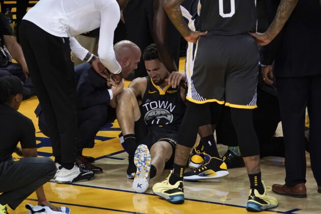 Golden State Warriors guard Klay Thompson, center, is helped up after being injured during the second half of Game 6 of basketball's NBA Finals against the Toronto Raptors in Oakland, Calif., Thursday, June 13, 2019. (AP Photo/Tony Avelar)