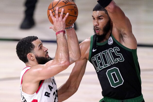 Toronto Raptors' Fred VanVleet, left, goes up for a shot against Boston Celtics' Jayson Tatum during the first half of an NBA conference semifinal playoff basketball game Friday, Sept. 11, 2020, in Lake Buena Vista, Fla. (AP Photo/Mark J. Terrill)