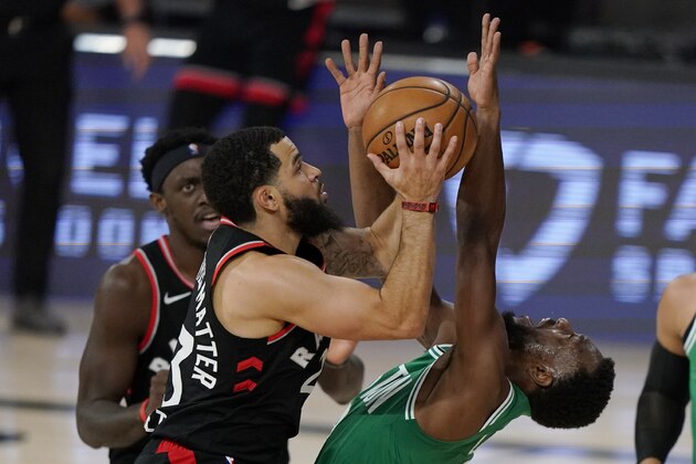 Toronto Raptors' Fred VanVleet, left, collides with Boston Celtics' Kemba Walker, right, as he goes to the basket in the first half of an NBA conference semifinal playoff basketball game Thursday, Sept 3, 2020, in Lake Buena Vista Fla. (AP Photo/Mark J. Terrill)