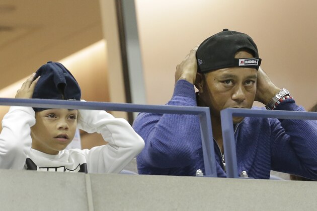 ADDS THE NAME OF TIGER WOODS SON, CHARLIE - Golfer Tiger Woods watches a match between Rafael Nadal, of Spain, and Marin Cilic, of Croatia, with his son, Charlie, during the fourth round of the U.S. Open tennis tournament, Monday, Sept. 2, 2019, in New York. (AP Photo/Seth Wenig)