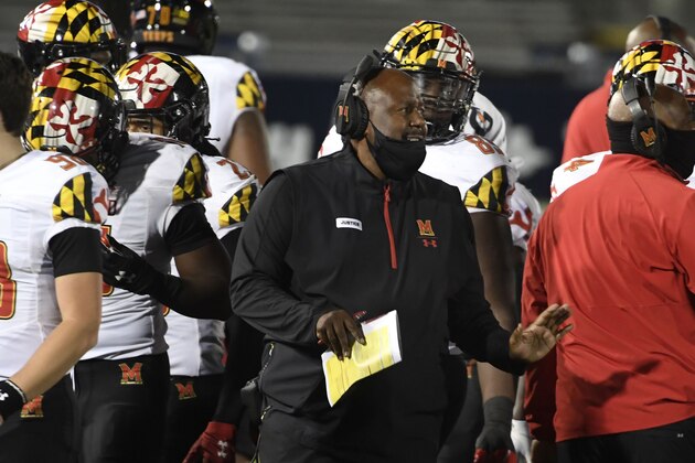 Maryland head coach Mike Locksley, center, talks with his players during a timeout late in the fourth quarter of an NCAA college football game in State College, Pa., Saturday, Nov. 7, 2020. (AP Photo/Barry Reeger)