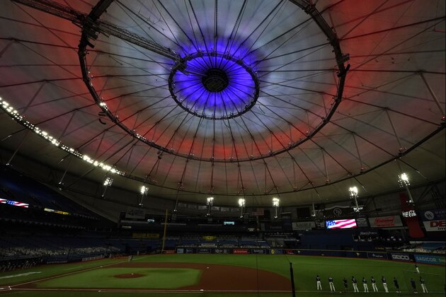 The roof inside Tropicana Field is illuminated red, white, and blue during the playing of the National Anthem before a baseball game between the Tampa Bay Rays and the Boston Red Sox Friday, Sept. 11, 2020, in St. Petersburg, Fla. Today marks the 19th anniversary of the Sept. 11, 2001 terrorist attacks. (AP Photo/Chris O'Meara)