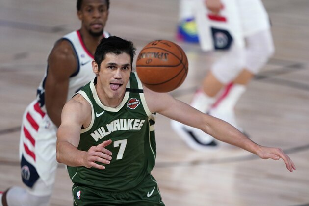 Milwaukee Bucks' Ersan Ilyasova (7) chases a loose ball during the first half of an NBA basketball game against the Washington Wizards, Tuesday, Aug. 11, 2020, in Lake Buena Vista, Fla. (AP Photo/Ashley Landis, Pool)